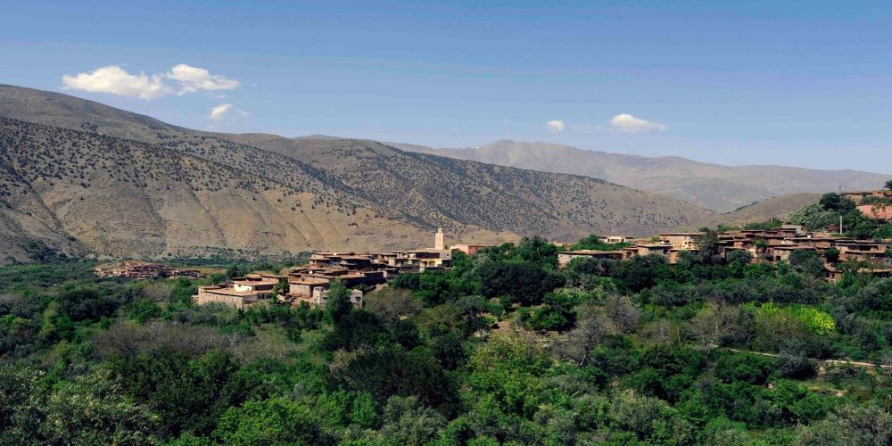 green valley with old buildings in atlas mountains