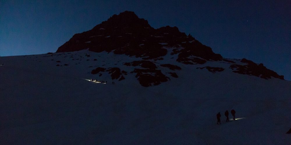 people walking on dark with with headlamp