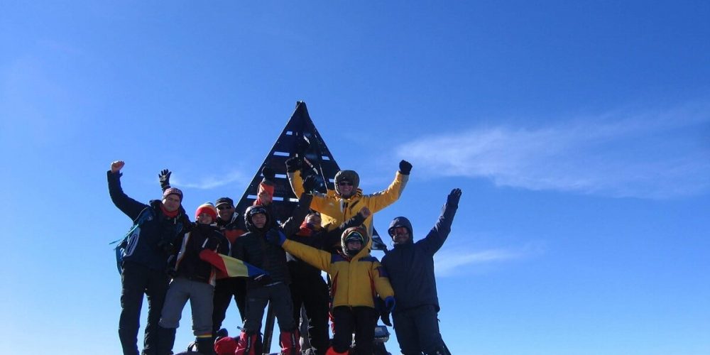 group of people at the summit of toubkal